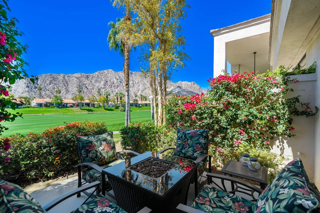 Patio with fire pit and floral cushions