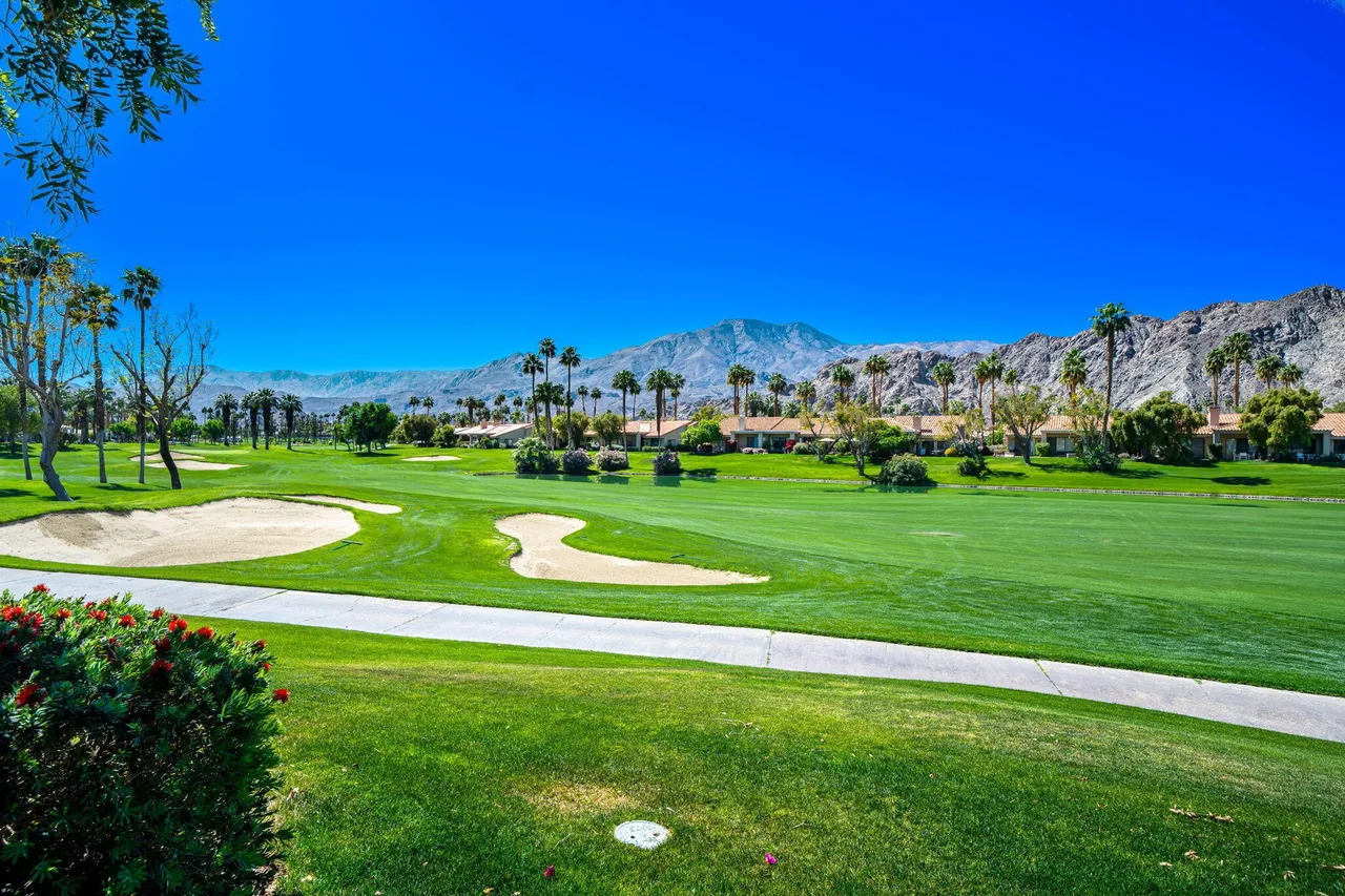 Golf course with sand bunkers, mountain view